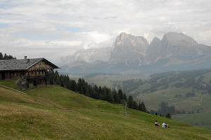 hikers resting on hillside in Dolomite Mtns, Italy hikers resting on hillside in Dolomite Mtns, Italy